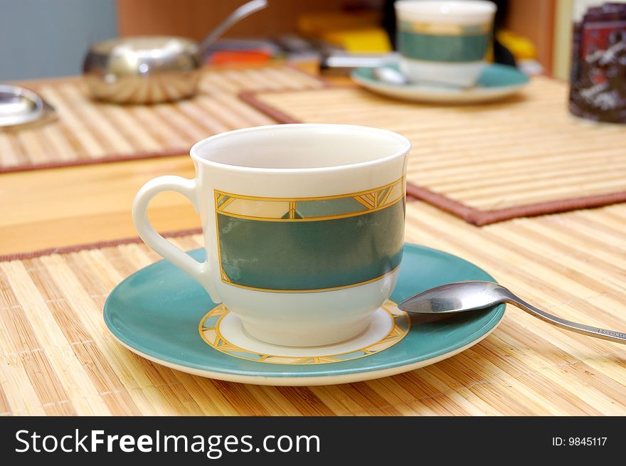 Empty cup on the table over bamboo mat