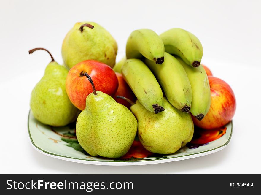 Pears, apples and bananas on a plate. Pears, apples and bananas on a plate