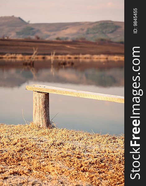 Wooden bench overlooking a rural dam in the Drakensberg area of South Africa. Wooden bench overlooking a rural dam in the Drakensberg area of South Africa