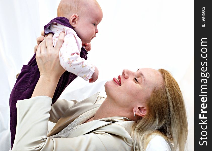 Portrait of mother with baby in playful mood. Portrait of mother with baby in playful mood.