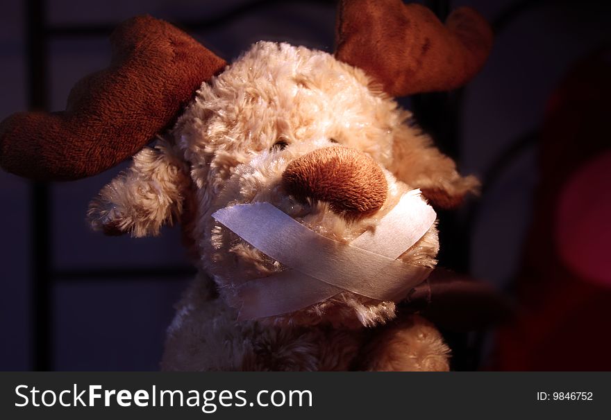 Restrained stuffed animal with ducktape on his mouth