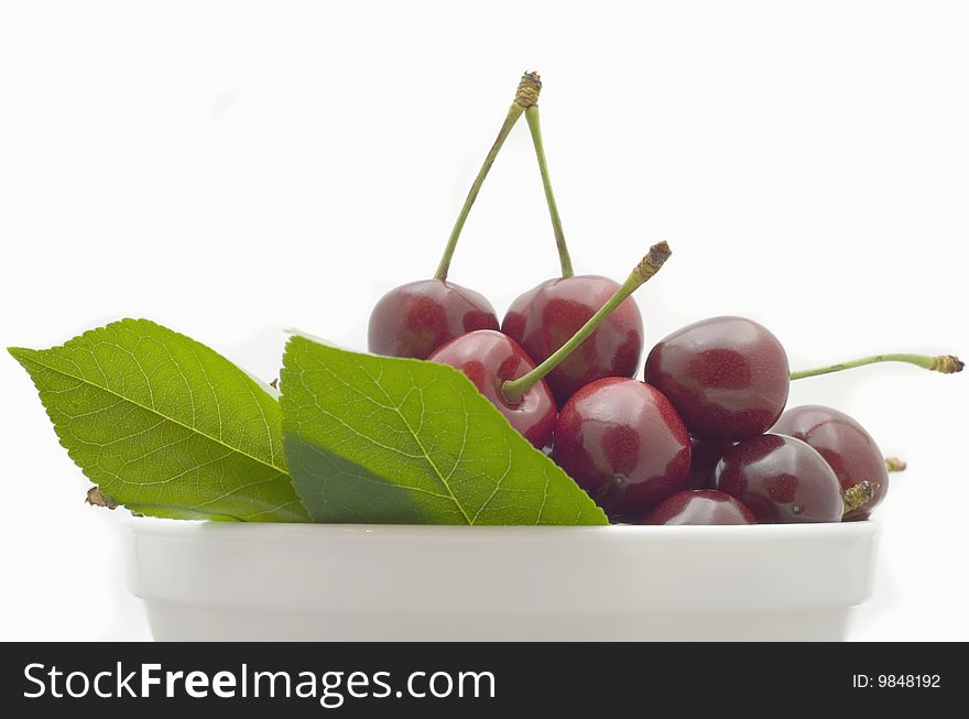 Berries red cherry in white bowl isolated on white background. Berries red cherry in white bowl isolated on white background