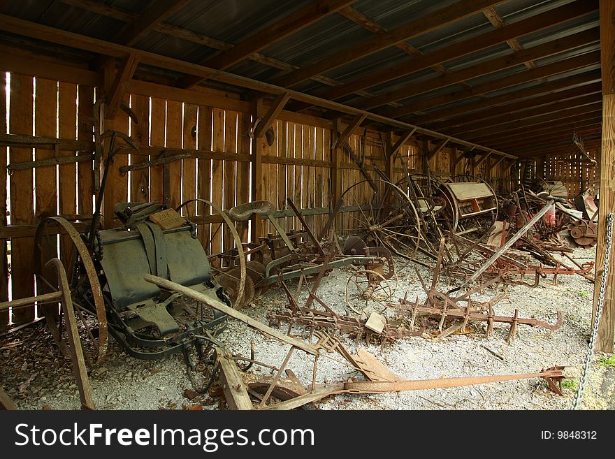 American 1800 farm tools rusting in shack.