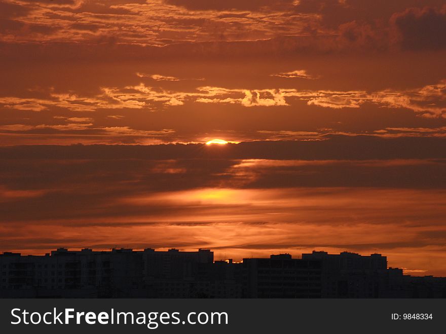 Bright Red Cloud Sunset Over The City