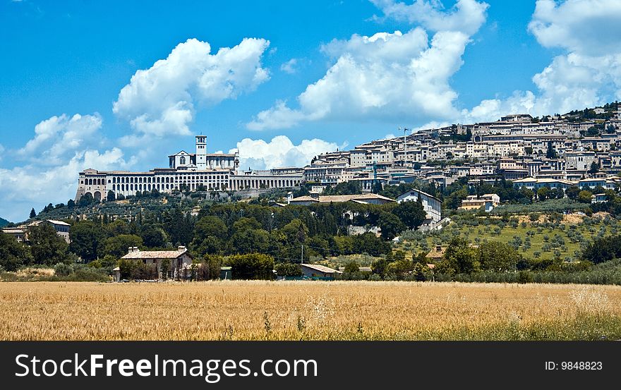 Assisi is surrounded by crops and agricultural landscapes. Basilica and friary, as seen from the plain below. Assisi is surrounded by crops and agricultural landscapes. Basilica and friary, as seen from the plain below