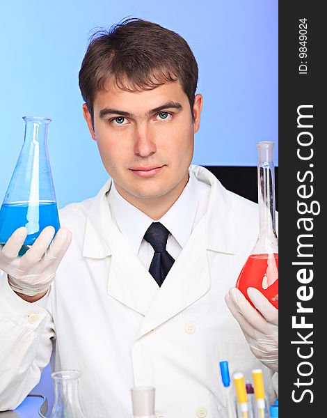 Medical theme: serious doctor working in a laboratory. Medical theme: serious doctor working in a laboratory.