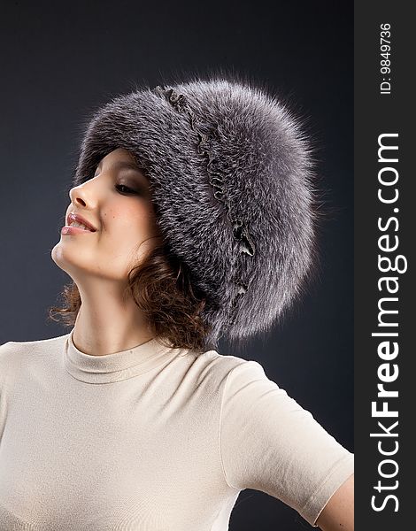 Young attractive woman in a fur hat