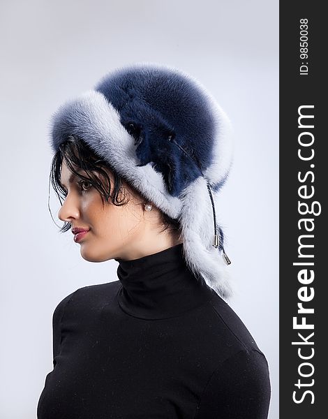 Young attractive woman in a fur hat