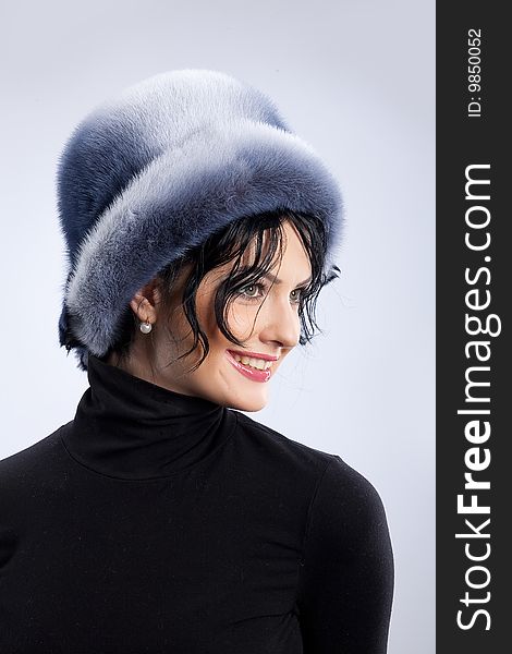 Young attractive woman in a fur hat