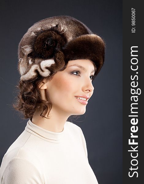 Young attractive woman in a fur hat