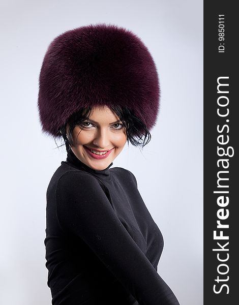 Young attractive woman in a fur hat