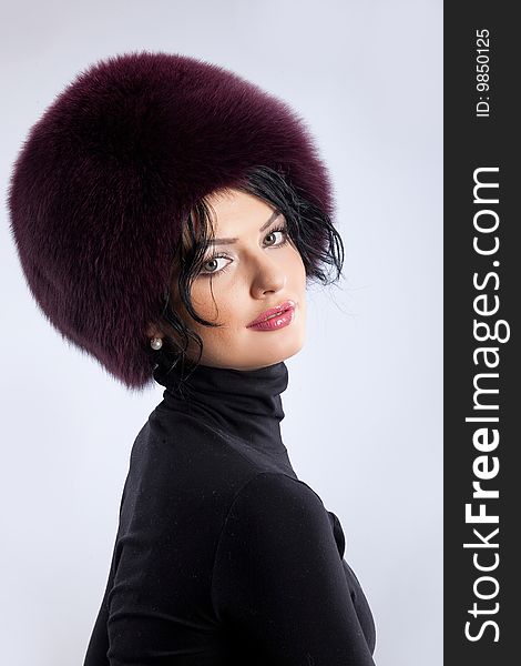 Young attractive woman in a fur hat