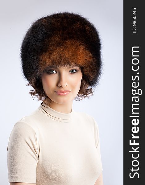Young attractive woman in a fur hat