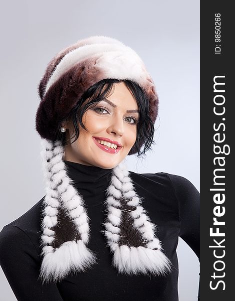 Young attractive woman in a fur hat