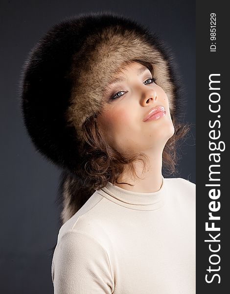 Young attractive woman in a fur hat