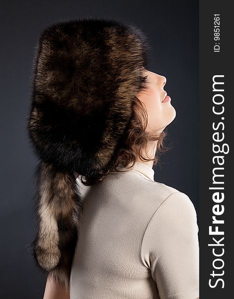 Young attractive woman in a fur hat