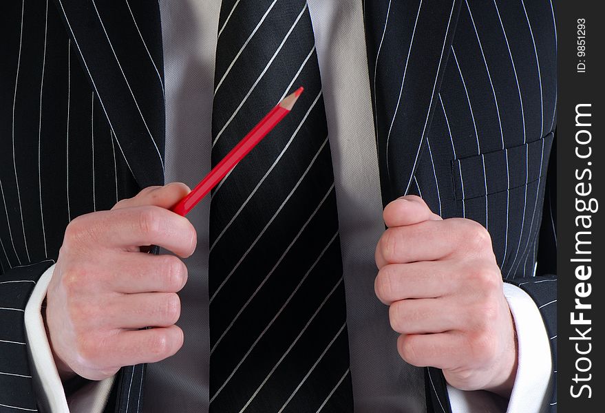 Businessman gesticulates with  pencil in  hand on  background of  suit