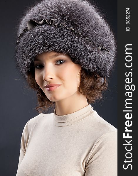 Young attractive woman in a fur hat