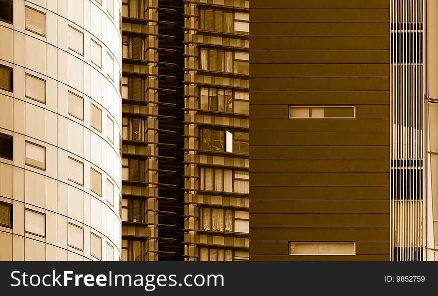 Abstract created from the juxtaposition of high rise modern buildings in close proximity in a city, rendered in sepia. Abstract created from the juxtaposition of high rise modern buildings in close proximity in a city, rendered in sepia