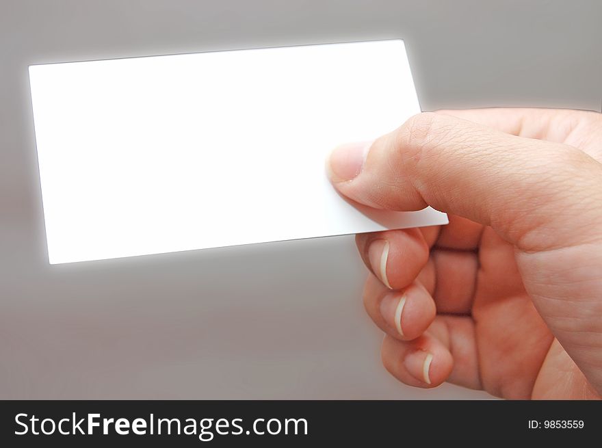 Paper card in woman hand grey background