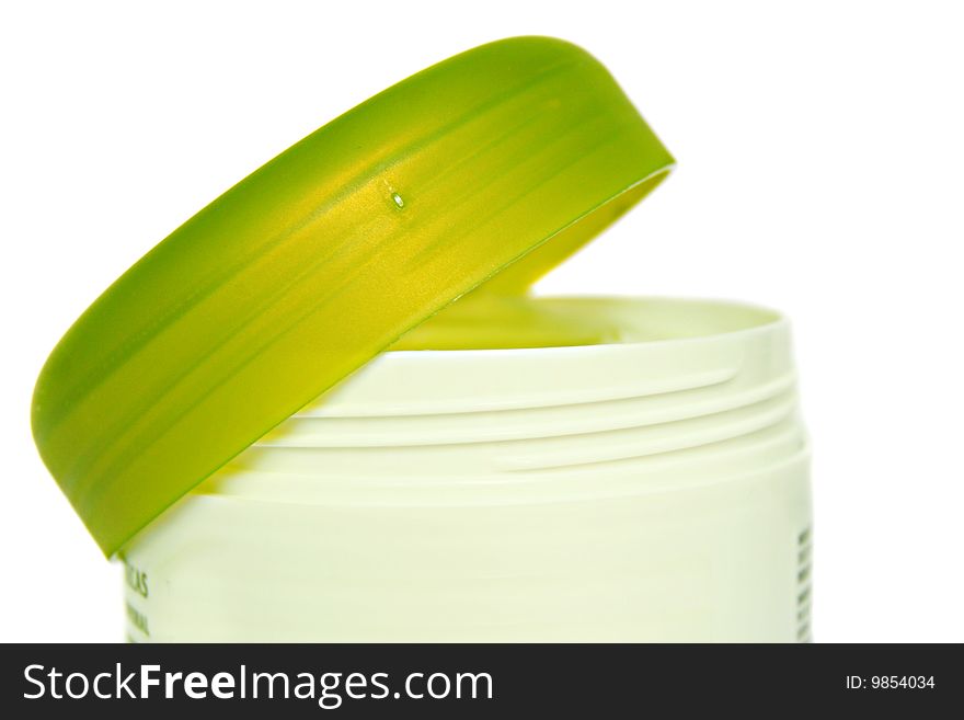 An image of a green pot cream over white
