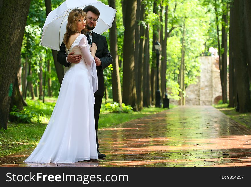 Just married bride and groom under rain. Just married bride and groom under rain