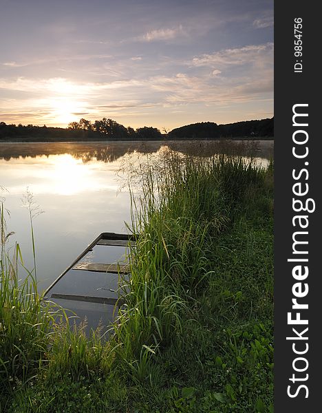 Sunrise on the artificial lake surrounded by forest. Sunrise on the artificial lake surrounded by forest