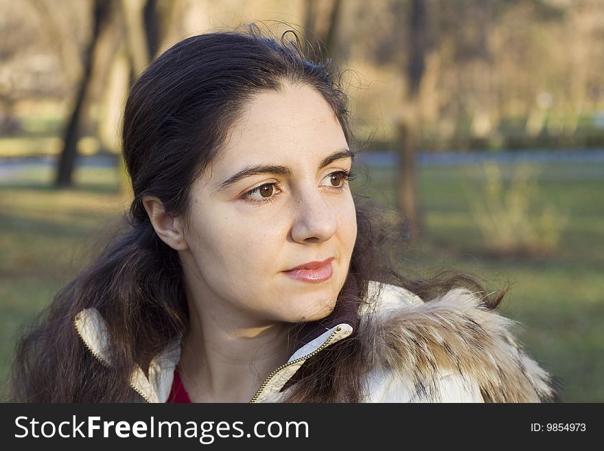 Young girl looking at the distance in the park