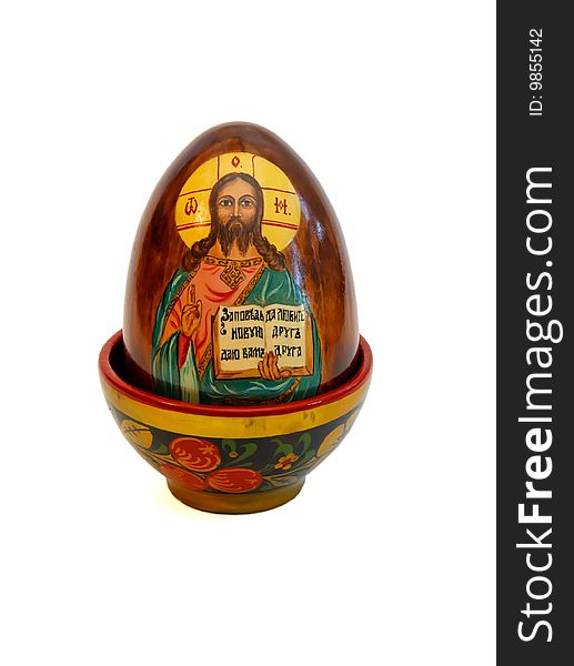 Russian easter egg with Jesus Christ in wooden cup on white background. Russian easter egg with Jesus Christ in wooden cup on white background