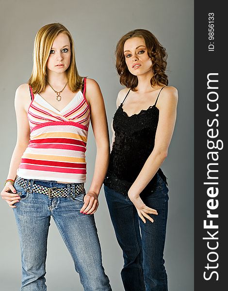 Fifteen and twenty-one year old sisters pose in studio. Fifteen and twenty-one year old sisters pose in studio.