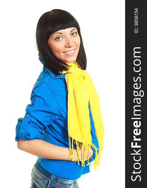 Portrait of a beautiful young brunette woman wearing a blue jacket and a yellow scarf