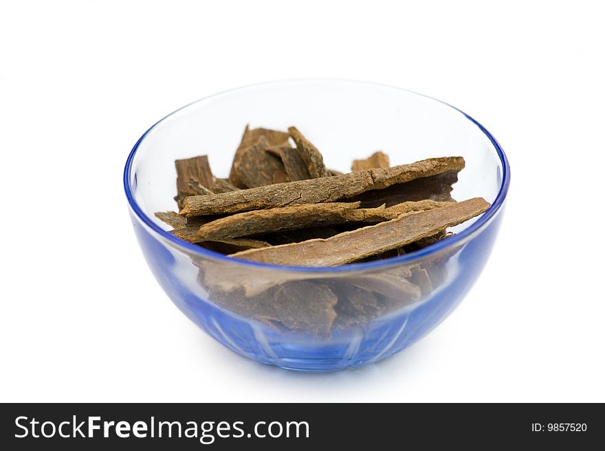 Dark  stick of cinnamon or dalchini  in a blue transparent bowl