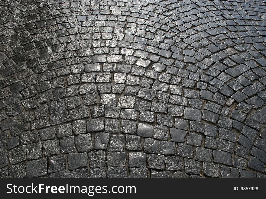 Part of a cobblestone pavement after the rain