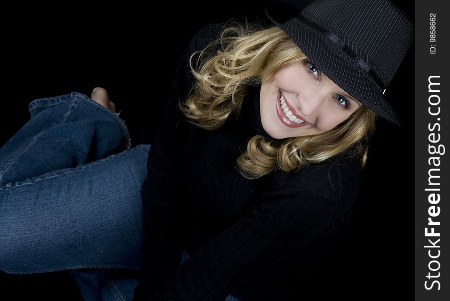 Beautiful blue eyed blond wearing a black hat. Beautiful blue eyed blond wearing a black hat.