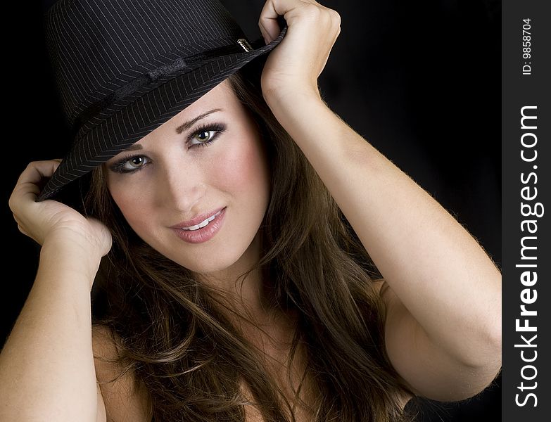Square portrait of a beautiful brunette woman wearing a hat. Square portrait of a beautiful brunette woman wearing a hat