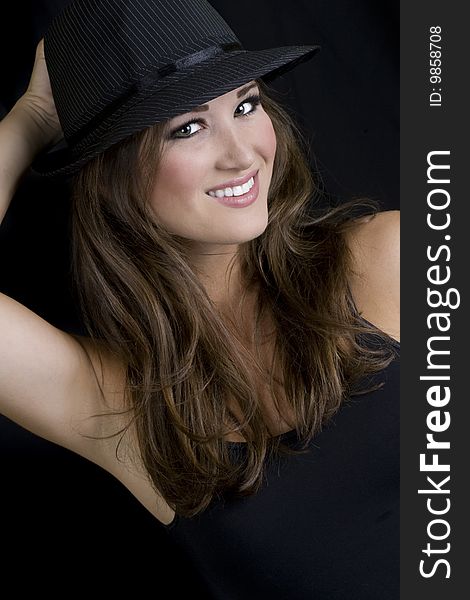 Portrait of a sexy brunette wearing a hat and smiling. Portrait of a sexy brunette wearing a hat and smiling