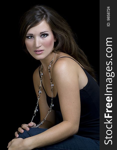 Sensual brunette wearing a long necklace. Sensual brunette wearing a long necklace