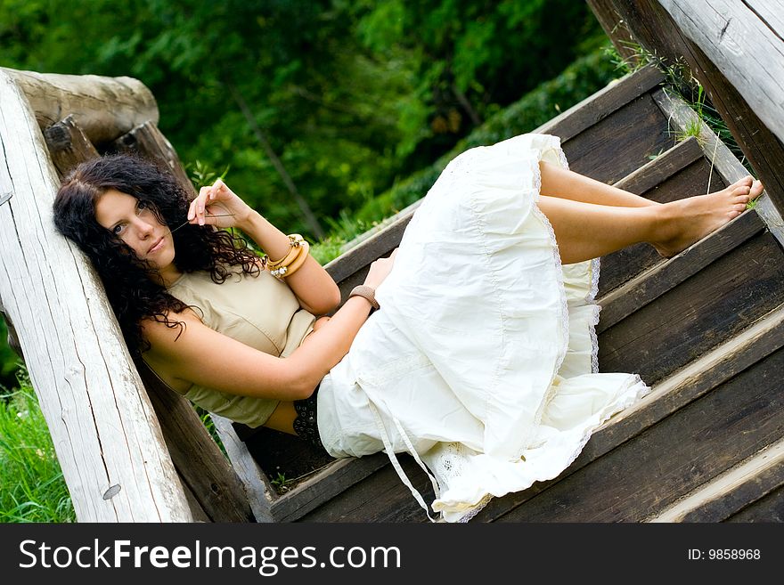 Woman sitting in wooden stairs