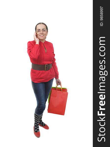 Lady in red with red shopping bag talking by phone. Lady in red with red shopping bag talking by phone