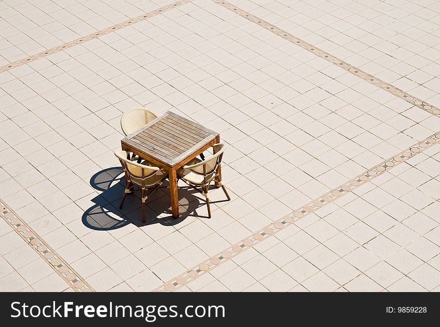 Table and chairs on tiled floor. Table and chairs on tiled floor