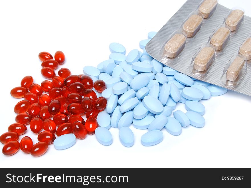 Colorful pills on white background