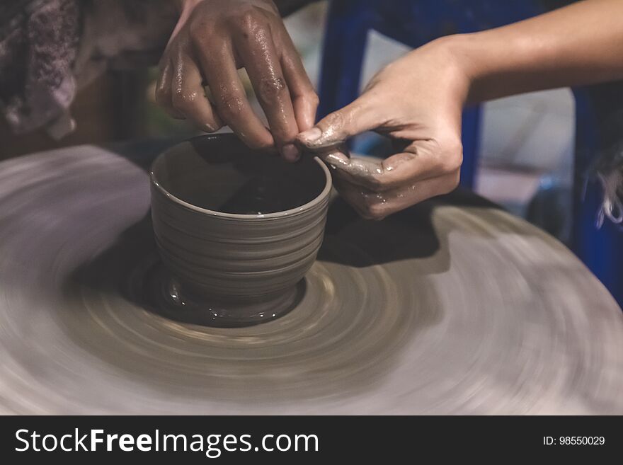 Professional Thai man using mechanic pottery make mug, earthenware at Night Plaza Market in Thailand. Professional Thai man using mechanic pottery make mug, earthenware at Night Plaza Market in Thailand.