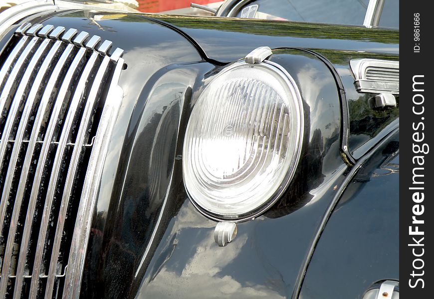 Black retro car on white background close-up