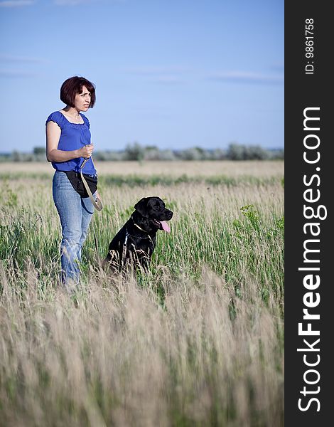 Woman with  dog in field. Woman with  dog in field