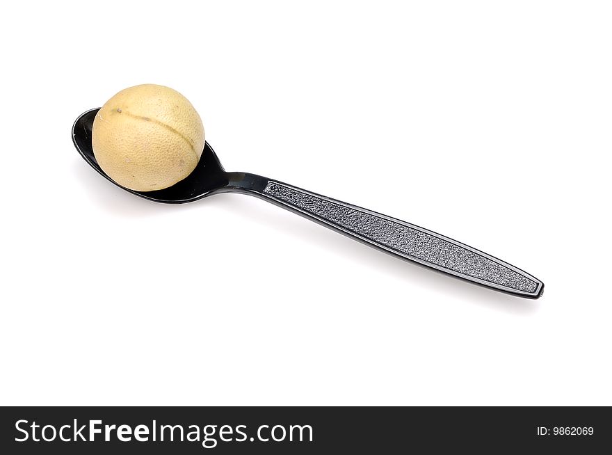 Lime in spoon isolated on white background.