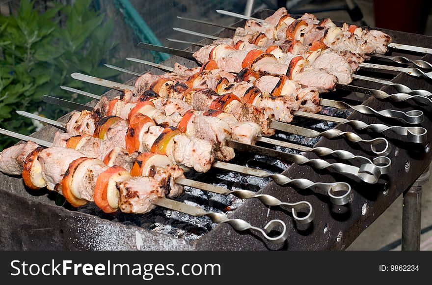 Big pieces of marinated pork with tomato and onion. Big pieces of marinated pork with tomato and onion