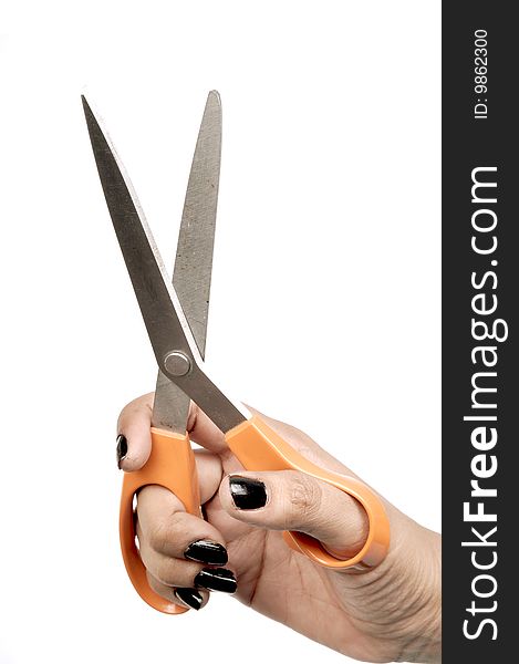 Female hand with orange scissor.