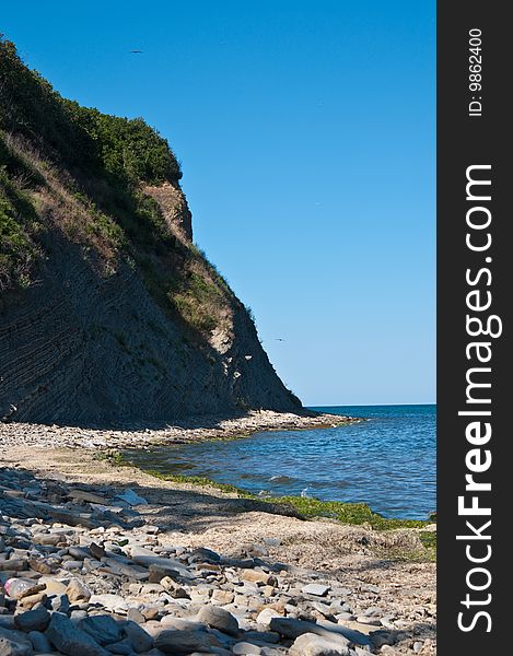 Rock on a deserted stony beach near the black sea