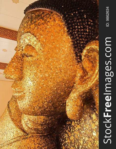 Reclining Buddha Image Covered With Gold Leaves