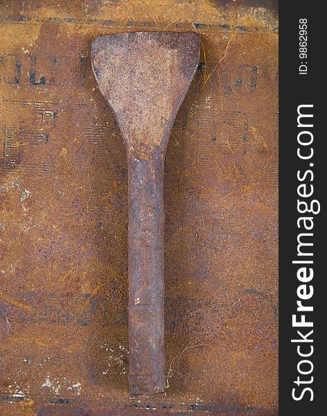 Rusted spatula on rusted background